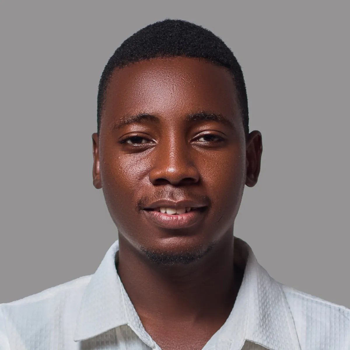 Jochua Mulambo sorridente, de camisa branca